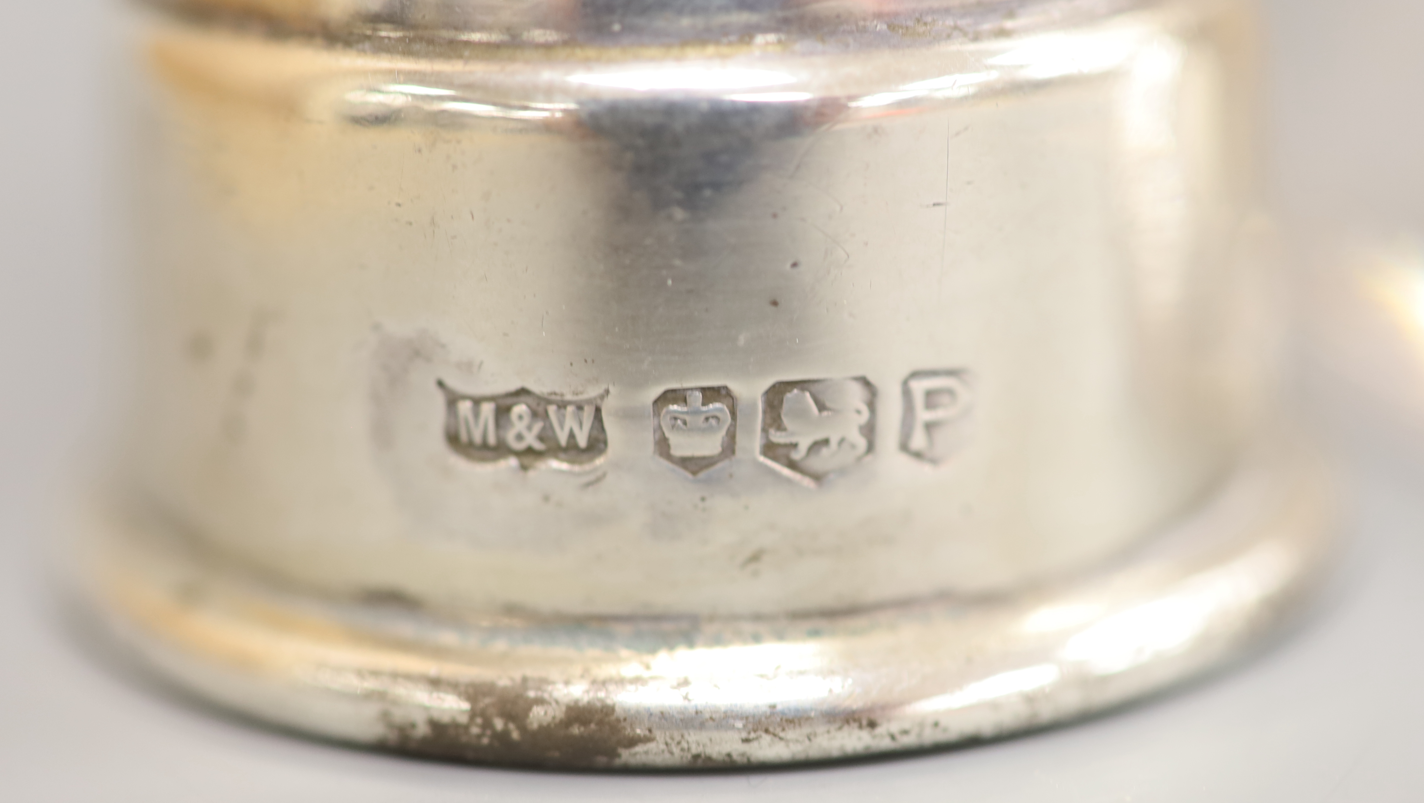 A modern silver pepper mill, Mappin & Web, Sheffield, 1957, 85mm and silver plated mounted glass sugar sifter.